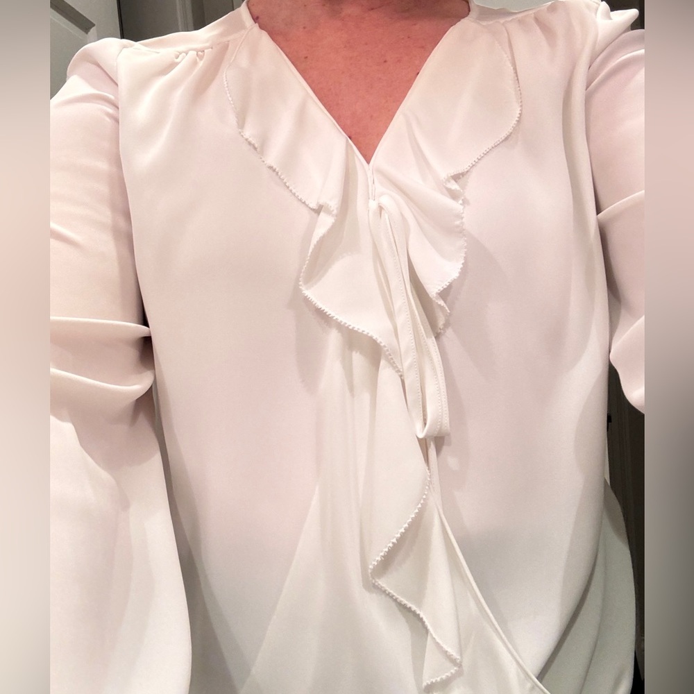 Cream blouse w ruffle faux wrap, v-neck, long sleeve. Chiffon crepe.